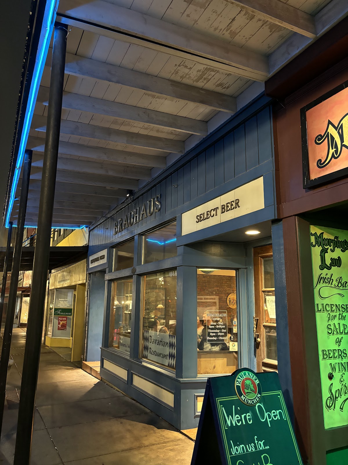 Bavarian Brauhaus blue storefront on North Main Street in Historic Downtown Bryan at dusk