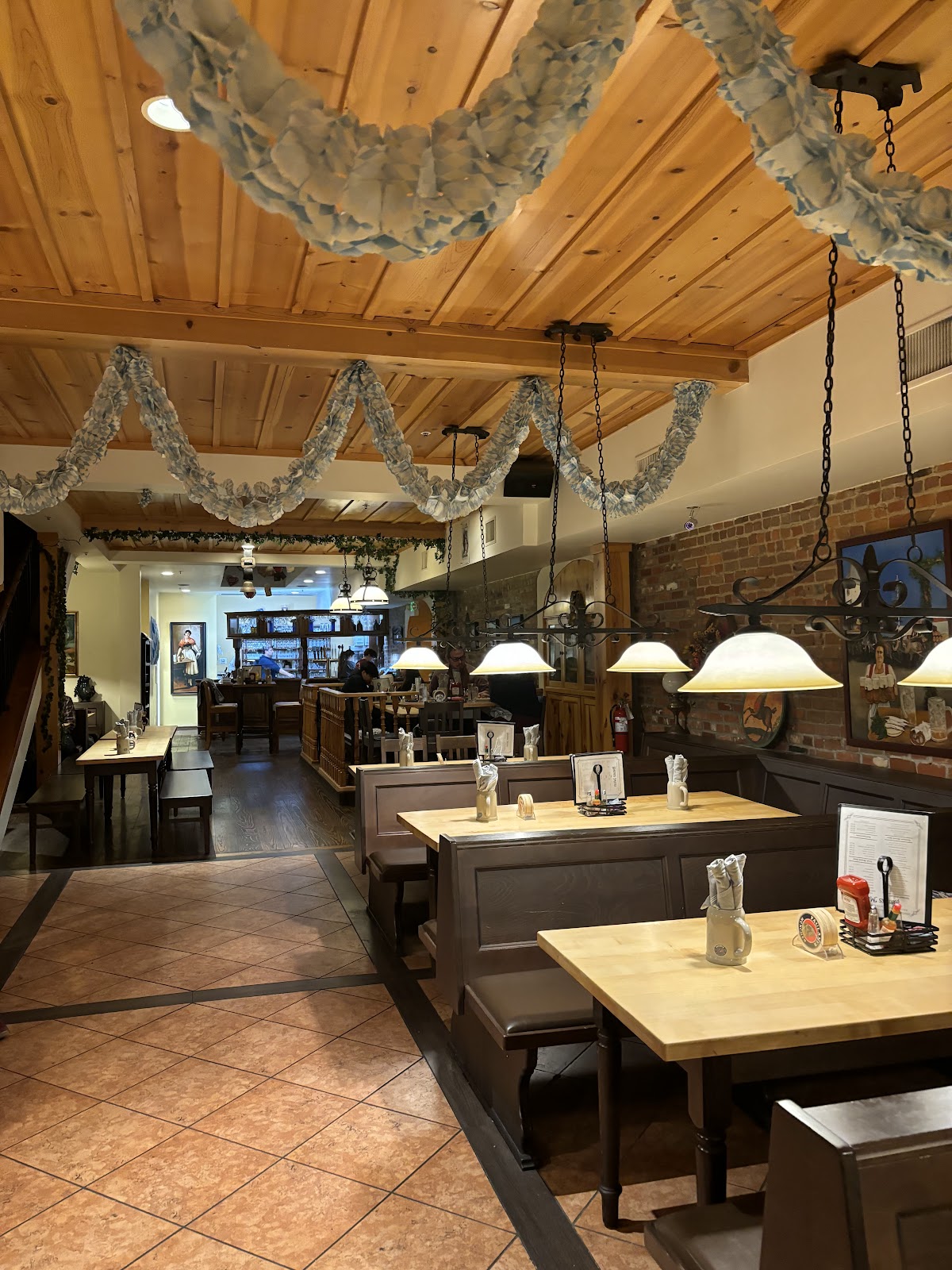 Inside Bavarian Brauhaus: pine ceilings, exposed brick, wooden booths and German decor