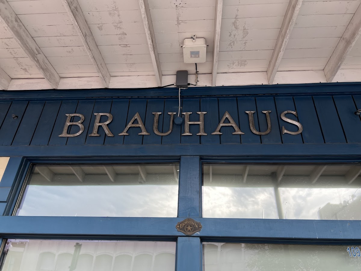 The carved Brauhaus sign on the blue Main Street storefront